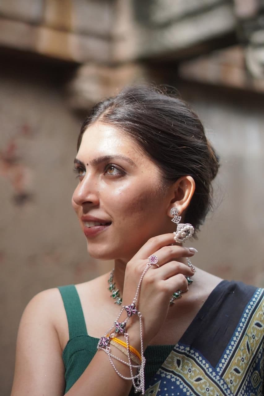 Model wearing an oxidised silver haathphool, jhumka and necklace