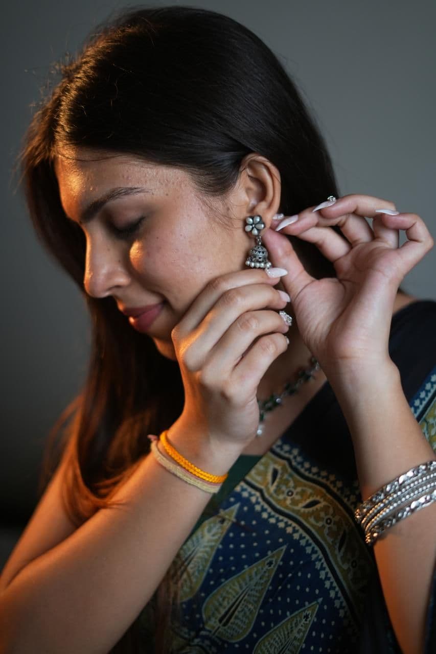Model fastening an oxidised silver jhumka