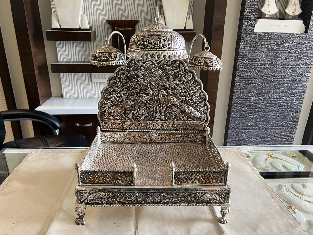 Hand-carved antique silver singhasan in the Pankaj Jewellers showroom