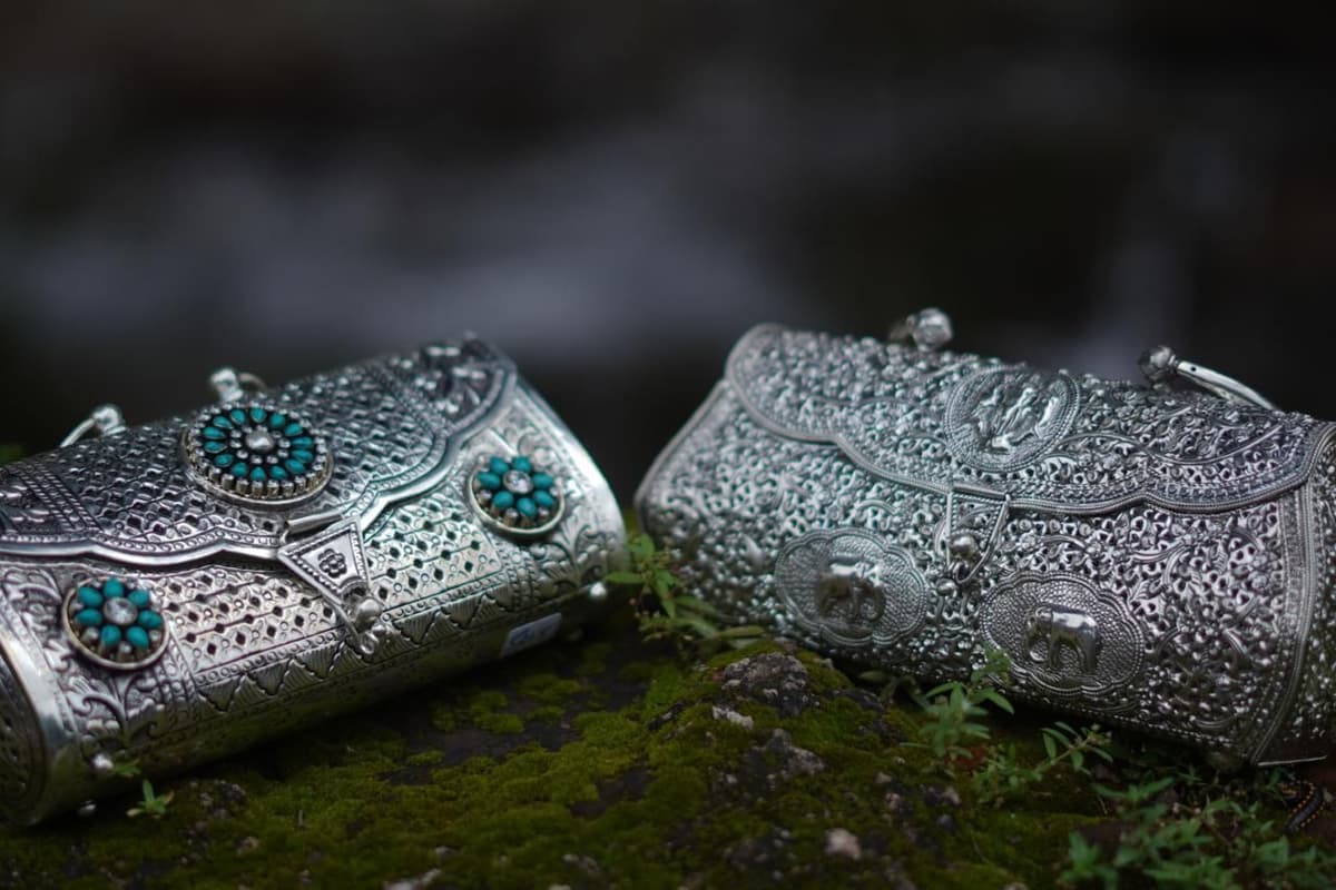 Two carved silver clutches